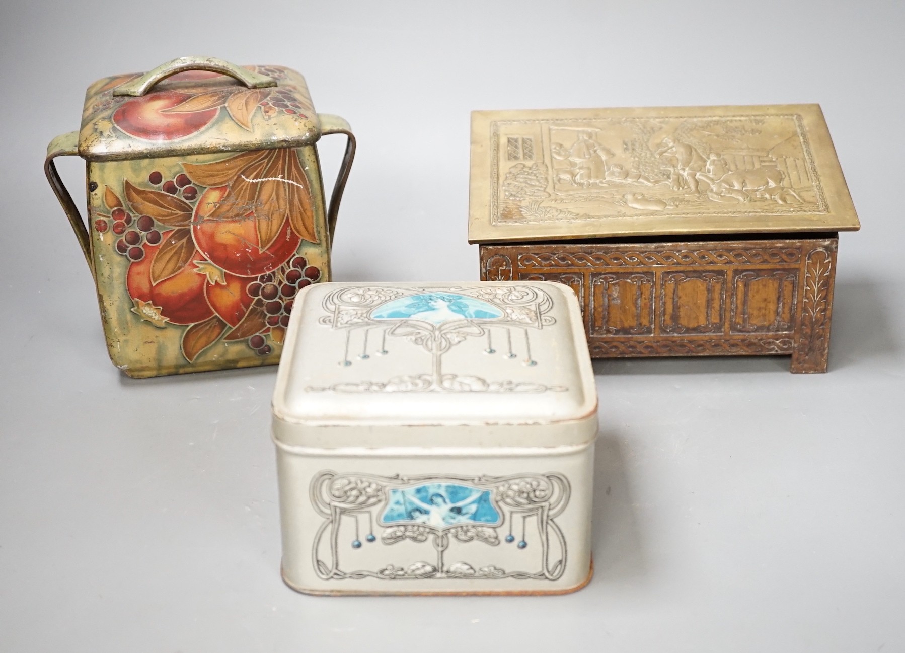 A Jacobs embossed coffer shaped biscuit tin, 16cm wide, a Pomegranate design tin after Moorcroft and one other biscuit tin, (3)